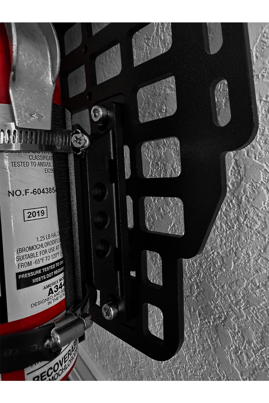 Red fire extinguisher mounted on a molle rack with a textured background