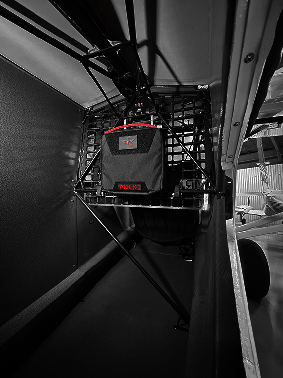 Toolkit attached to a Molle Rack with visible AeroTac branding inside an aircraft.