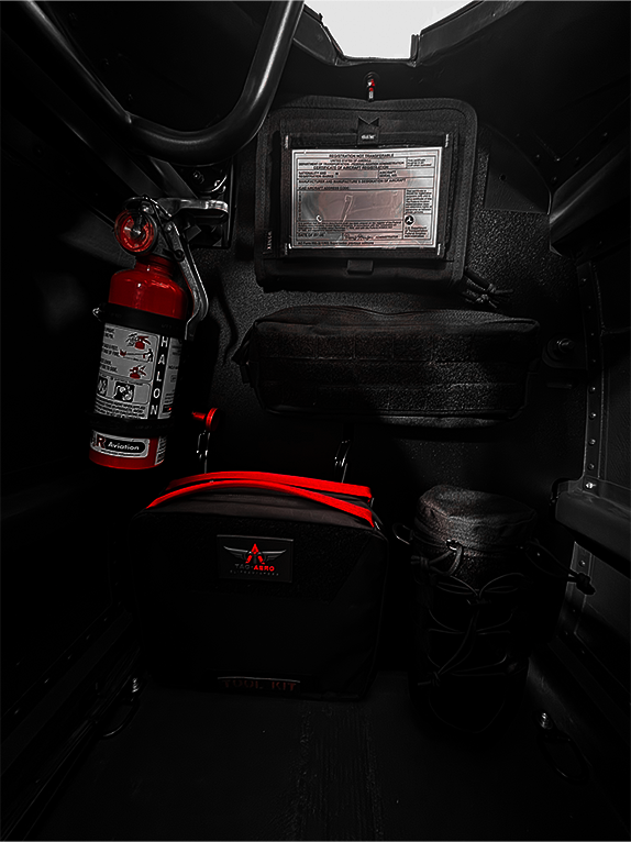 Tool kit and fire extinguisher attached to a Molle Rack in a vehicle's cargo area