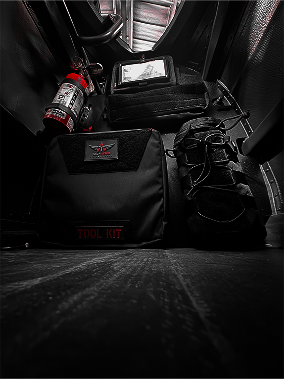 Tool kit and fire extinguisher attached to a Molle Rack in a vehicle's cargo area