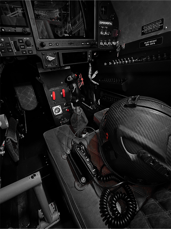 Close-up of a cockpit interior with control panels and a helmet.