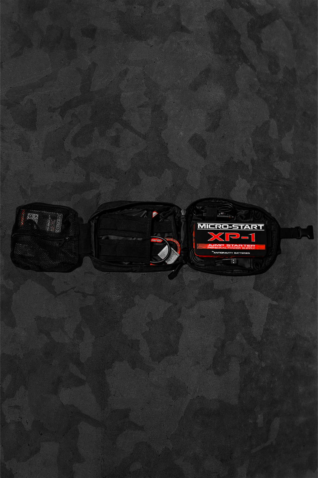 Black Jump Starter bag open showing the kit battery and cables on a dark background