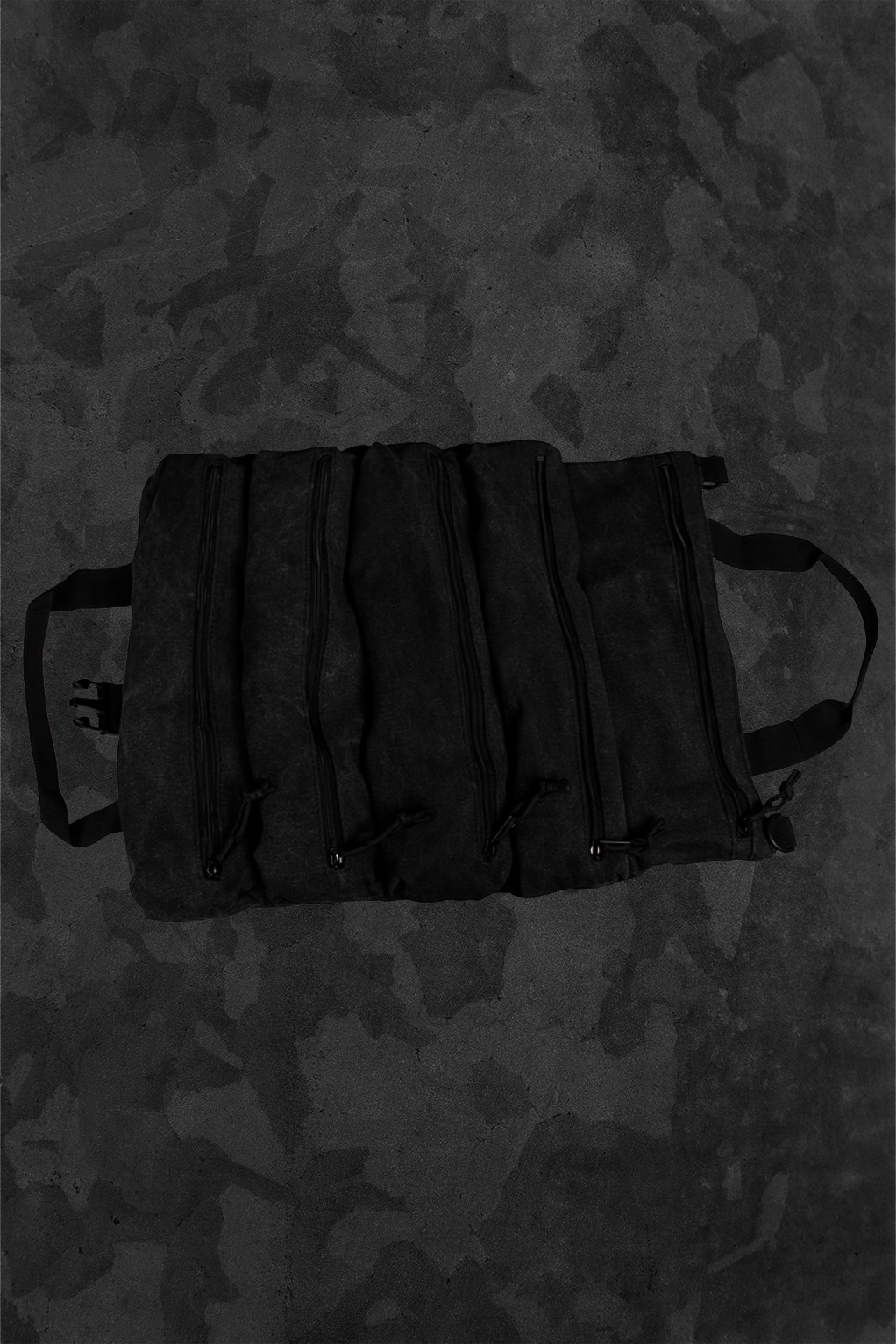 Black tie down kit bag with a TacAero logo on a dark camouflage background