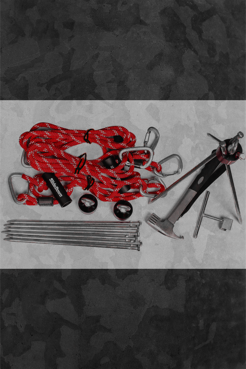 Set of tools including a red rope, hammer, and nails on a dark background