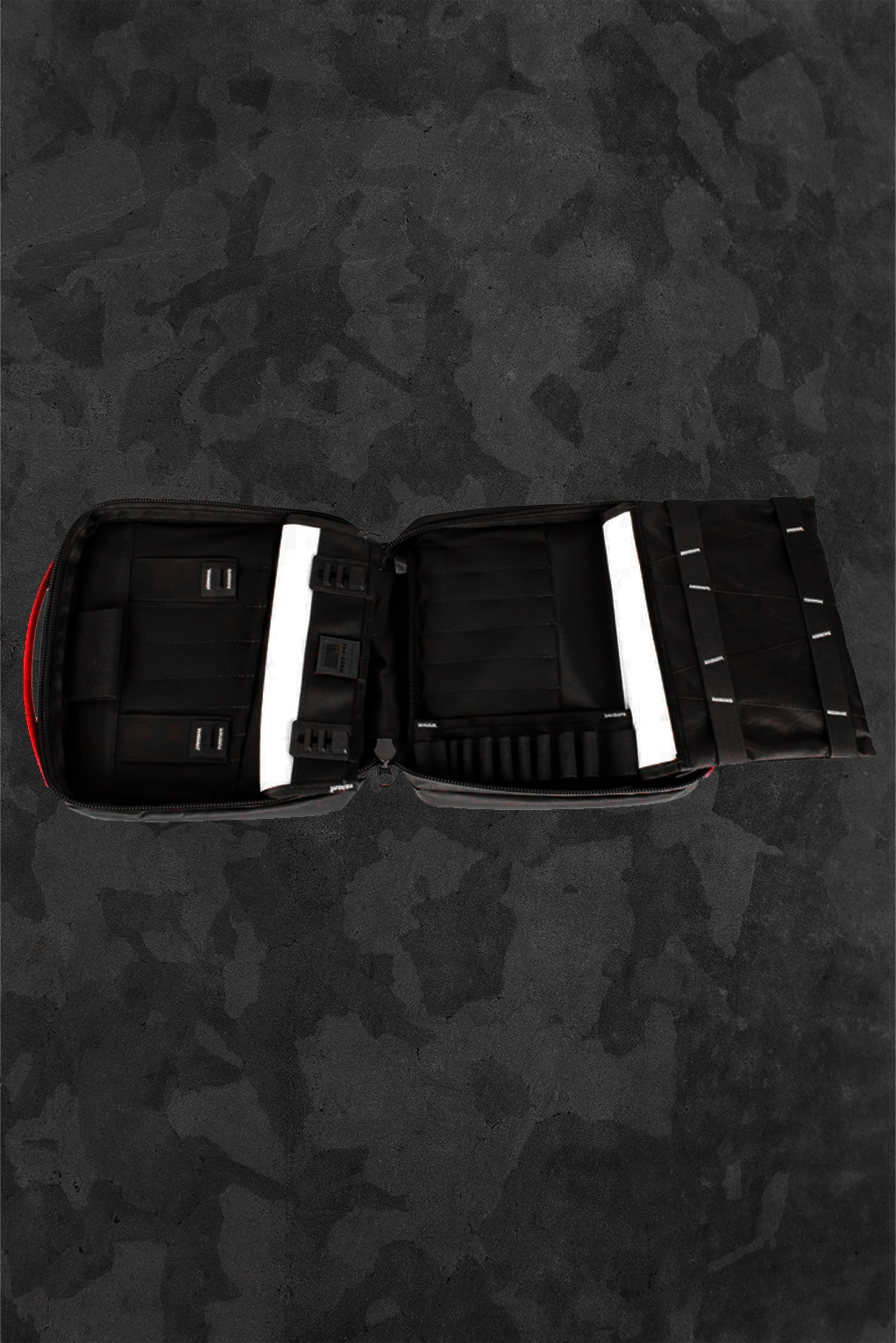 Open and empty toolkit on a dark camouflage background