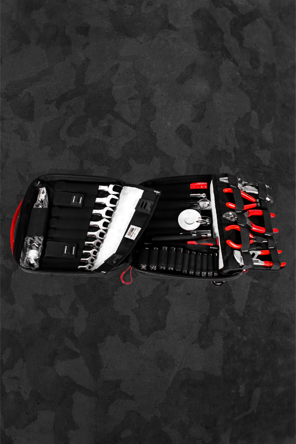 Open tool kit with various tools on a dark textured background